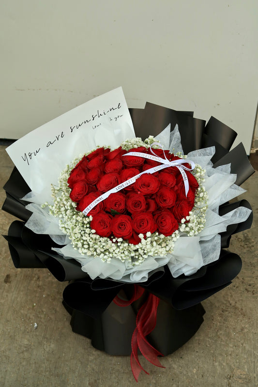 XL red rose bouquet with 35 fresh roses and baby's breath, wrapped in elegant white and black paper. Perfect for Valentine's Day, anniversaries, and romantic gifts. Available for same-day flower delivery in Kuala Lumpur & Selangor.